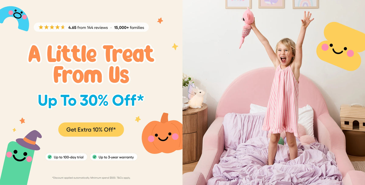 A promotional banner split into two sections: the left side features a pastel-colored graphic with the text 'A Little Treat From Us Up To 30% Off*' and cartoon illustrations, while the right side shows a young girl in a pink dress jumping happily on a pink bed in a child's bedroom.