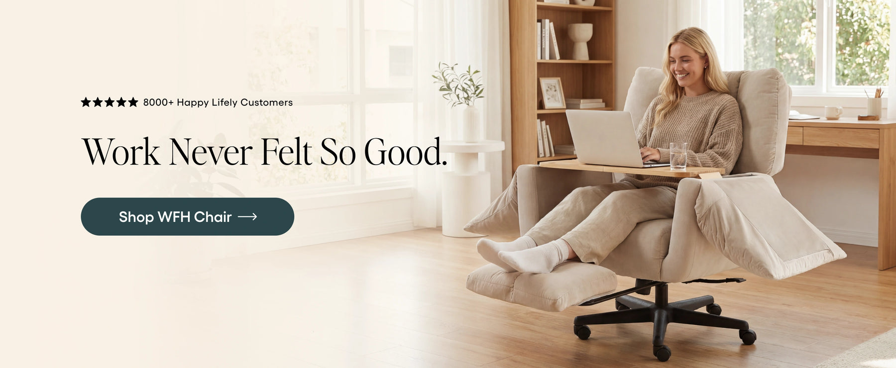 Woman using a laptop on a recliner chair with a home office setting.