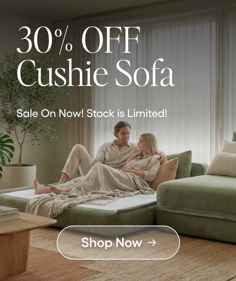 Couple sitting on a green sofa in a living room with promotional text overlay.