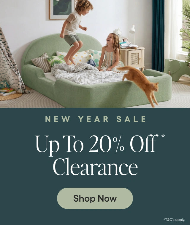 Children playing on a green bed with a 'New Year Sale' banner at the bottom.